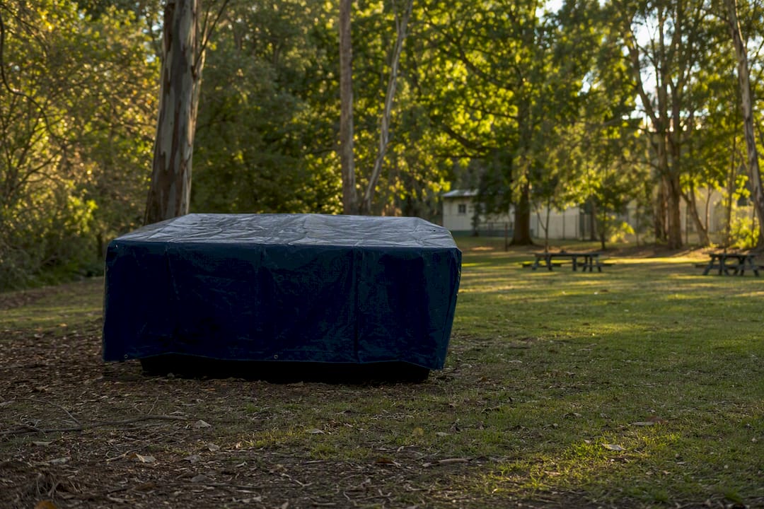 Skip bin covered with tarp on waste truck